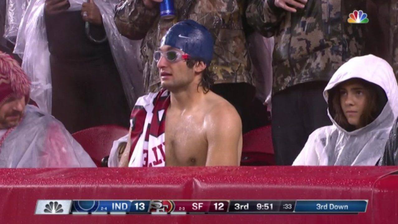 son wears cap and goggles to raining game